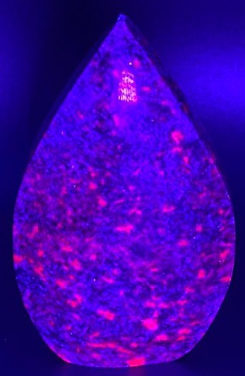 Sculptura de 7.9cm din cristal de corindon in cianit sub lumina UV