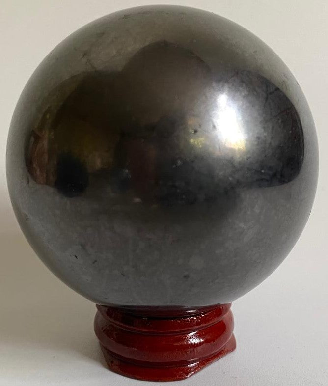 Sfera de 6cm din mineral de shungit pe suport din lemn cu fundal alb