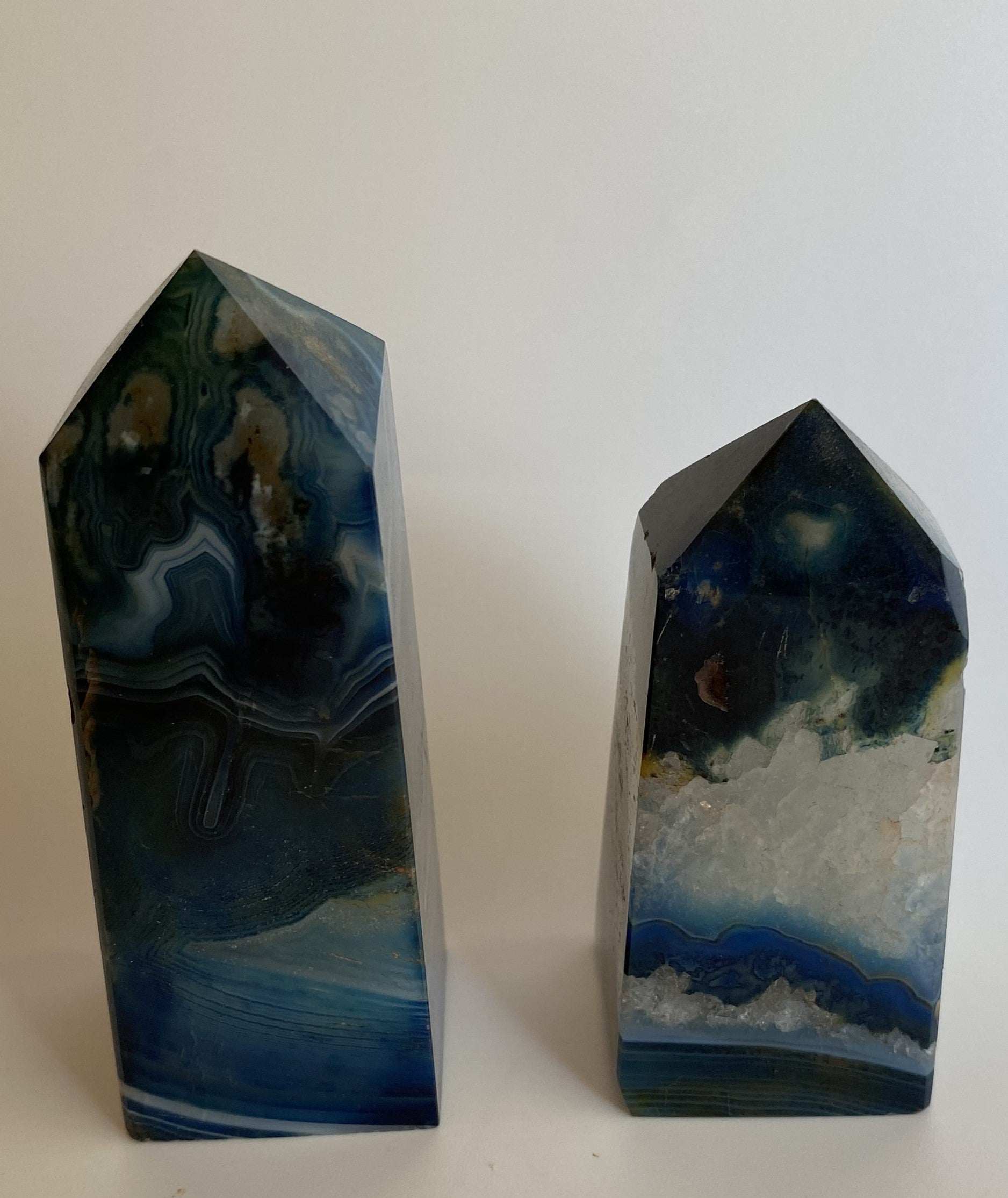Set of two blue agate obelisks with natural stone patterns