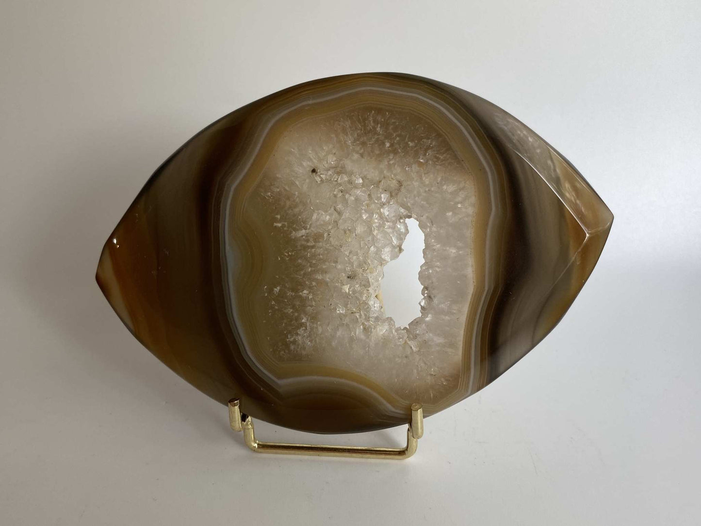 Agat Natural stone slice with metal stand on white background