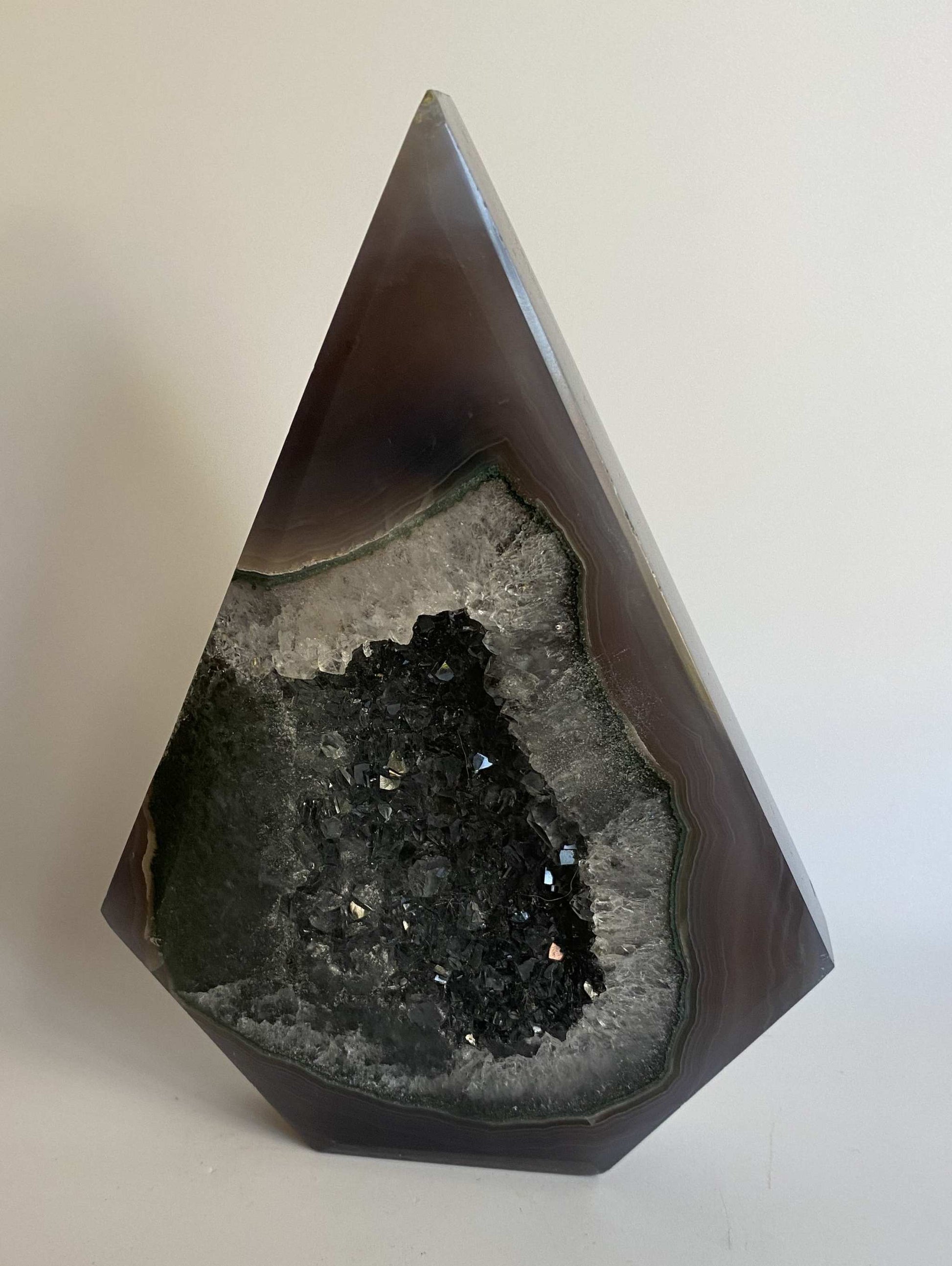 Agat Natural sculpted semiprecious stone with geode centerpiece on white background