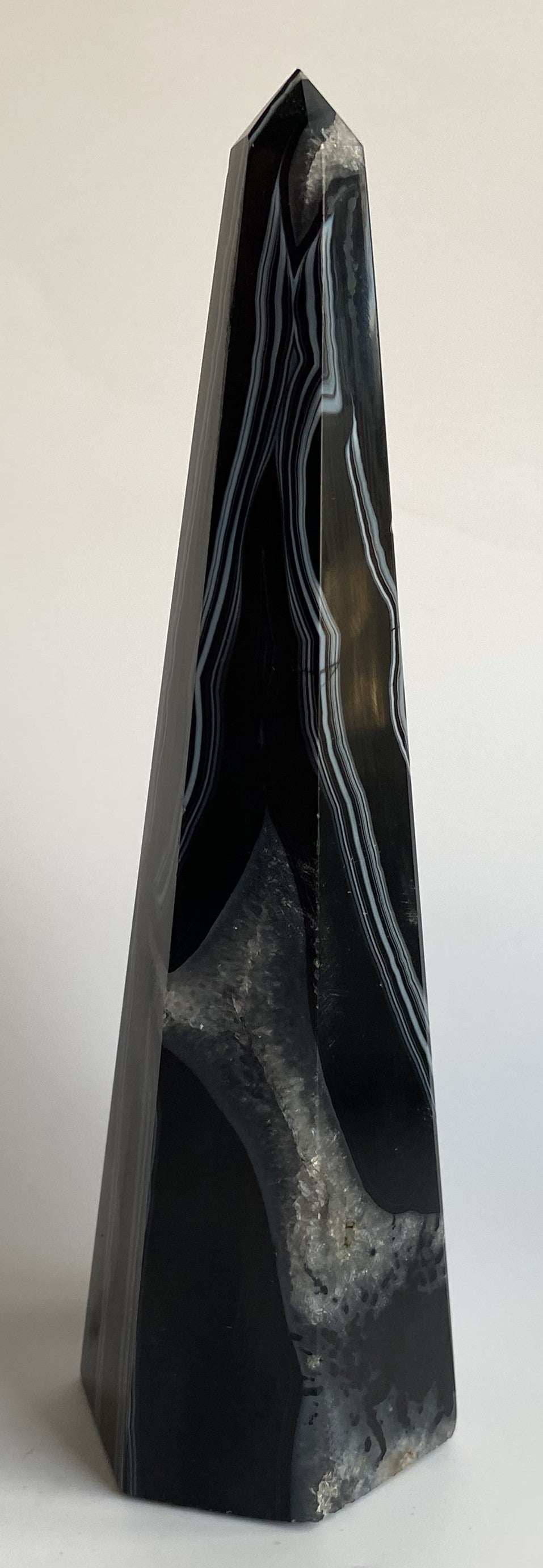 Obelisk pyramid made of black agate semiprecious stone with natural patterns
