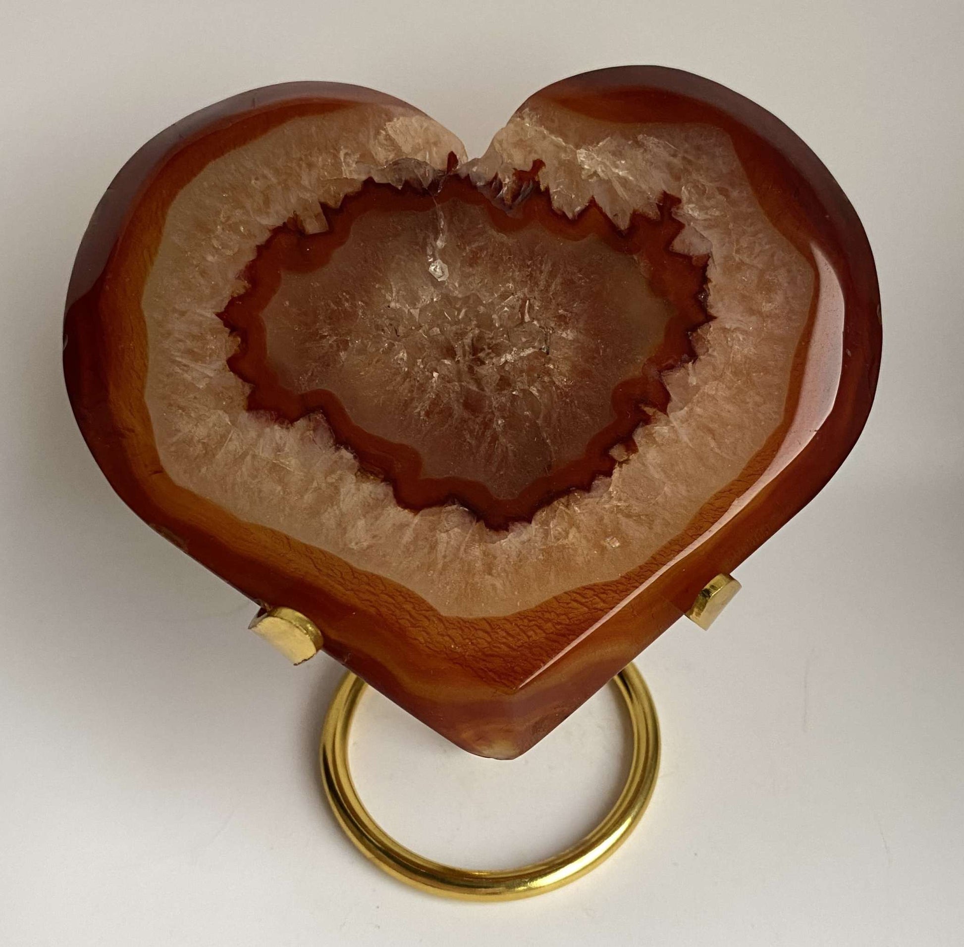 Heart-shaped Red Agate geode on a metal stand