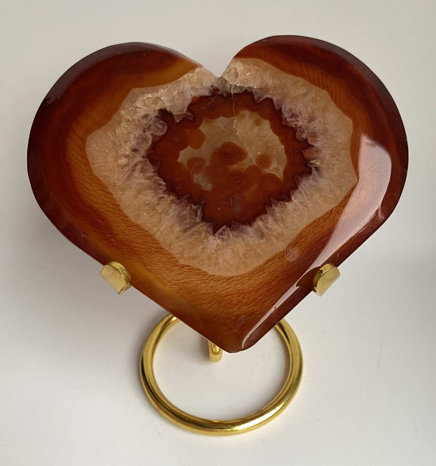 Heart-shaped red agate geode stone on metal stand Agat Rosu collectible