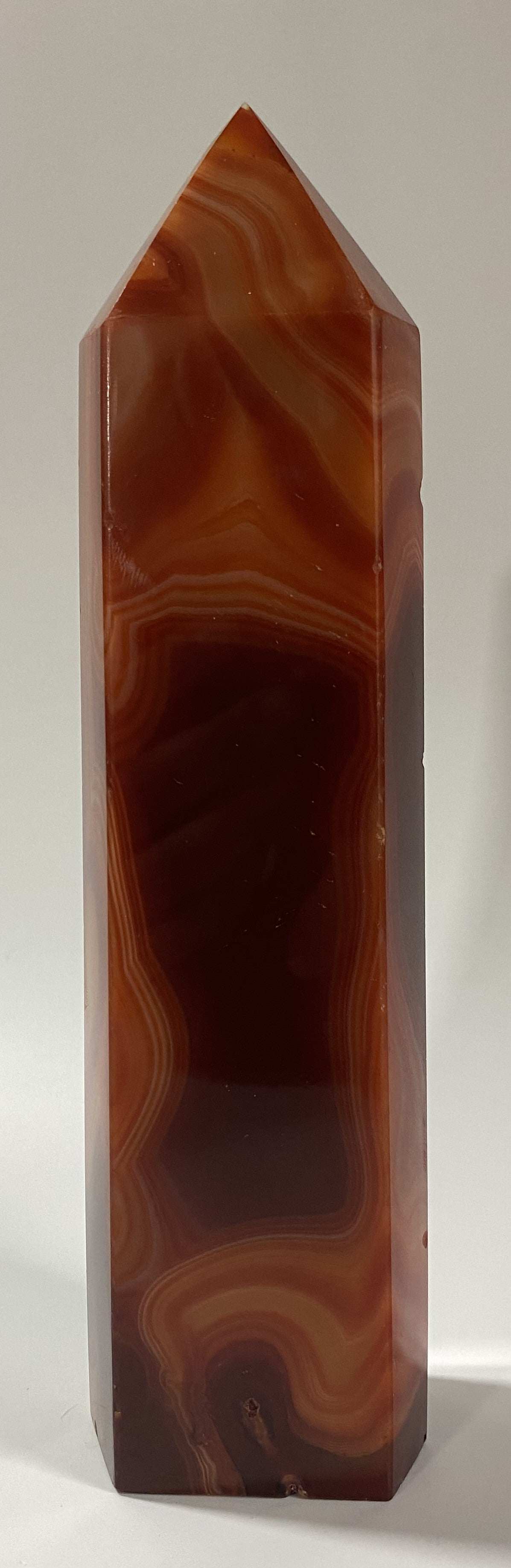 Obelisk made of red agate semiprecious stone with natural banded patterns