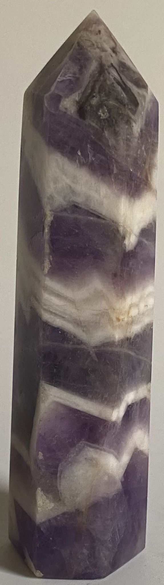 Obelisc din cristal de ametist chevron pe fundal alb
