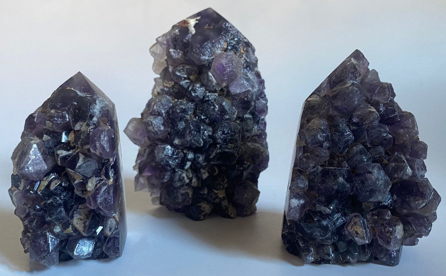 Set obeliscuri din piatra semipretioasa de geoda de ametist pe fundal alb