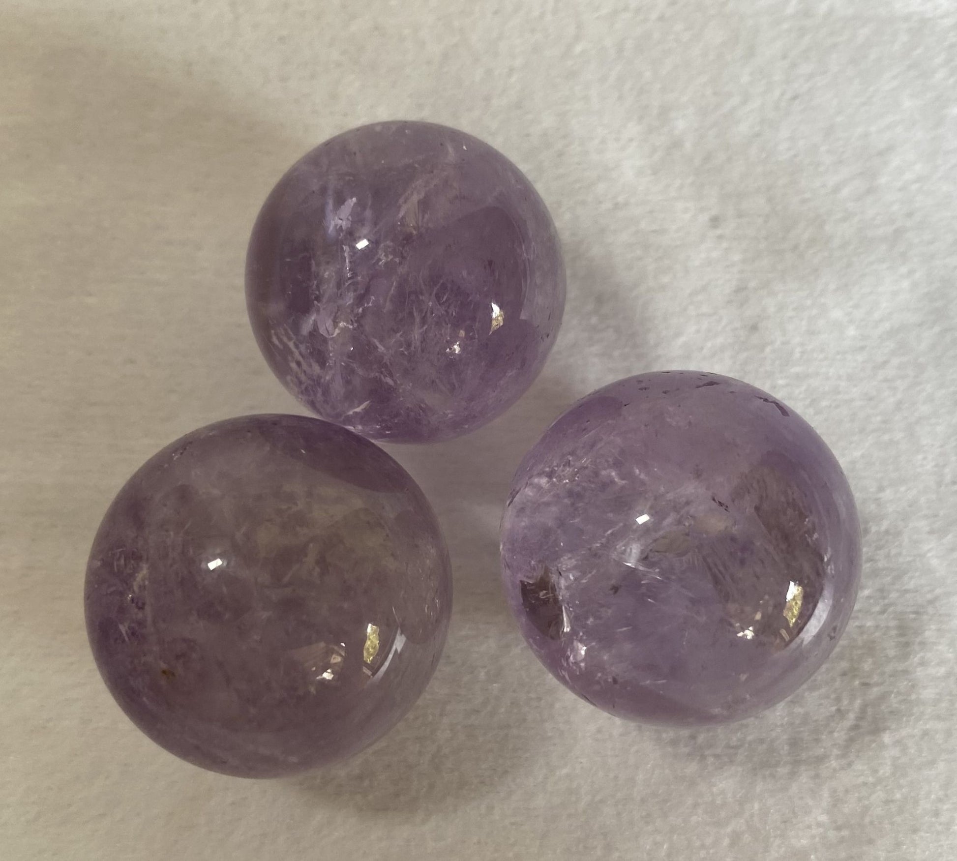 Set sfere din piatra semipretioasa de ametist pe fundal alb