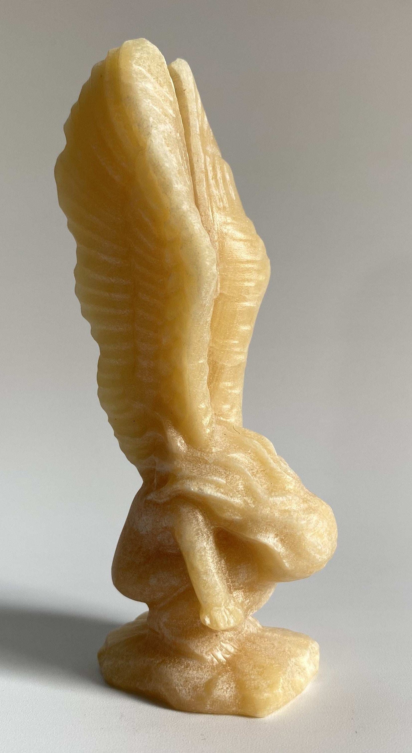 Yellow Calcit angel sculpture carved from semiprecious stone