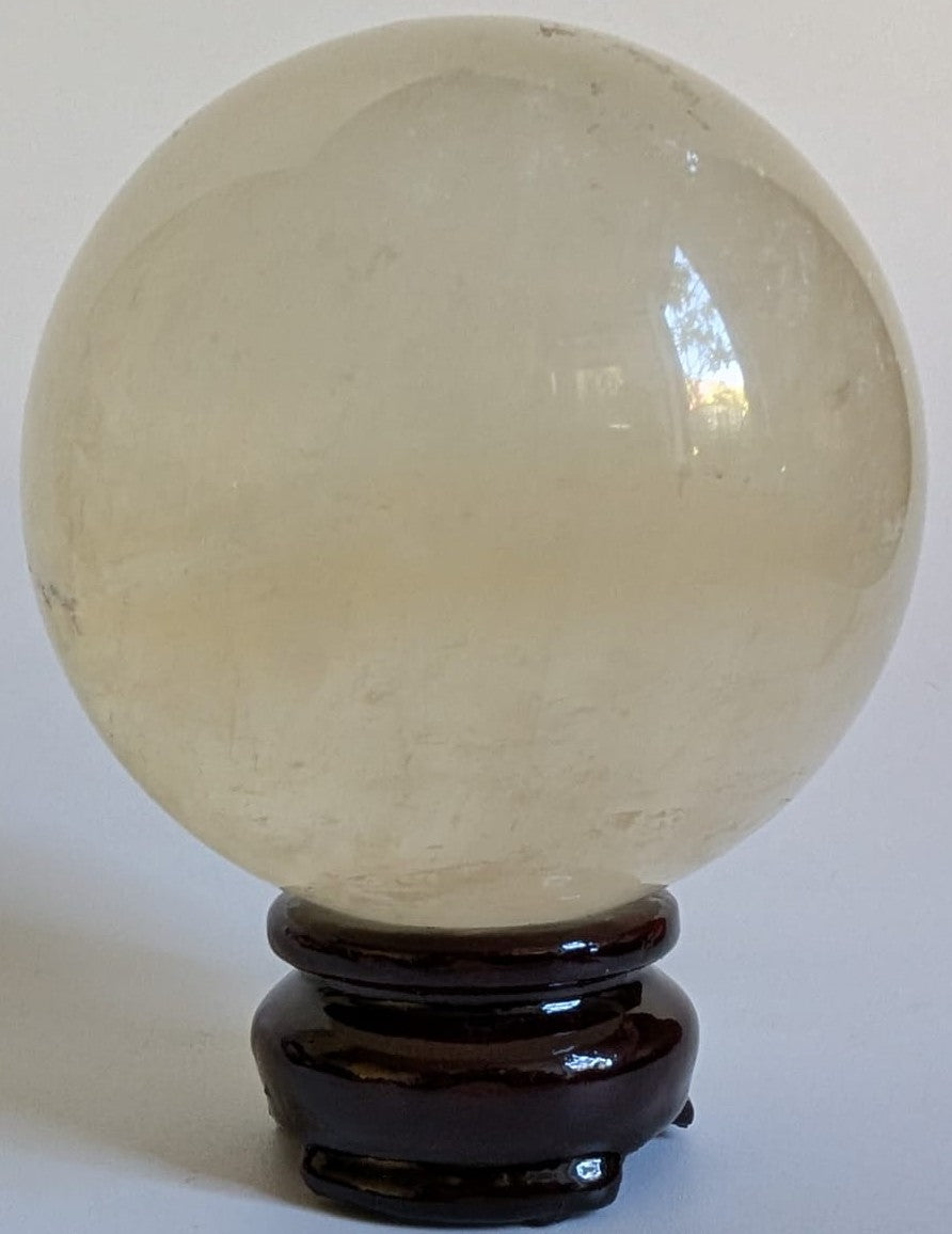 Sfera decorativa de 7.5cm din piatra semipretioasa de calcit Islanda pe suport din lemn cu fundal alb