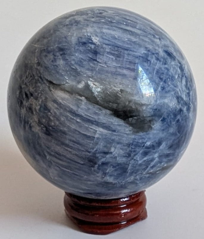 Sfera decorativa de 6.1cm din cristal de cianit pe suport din lemn cu fundal alb