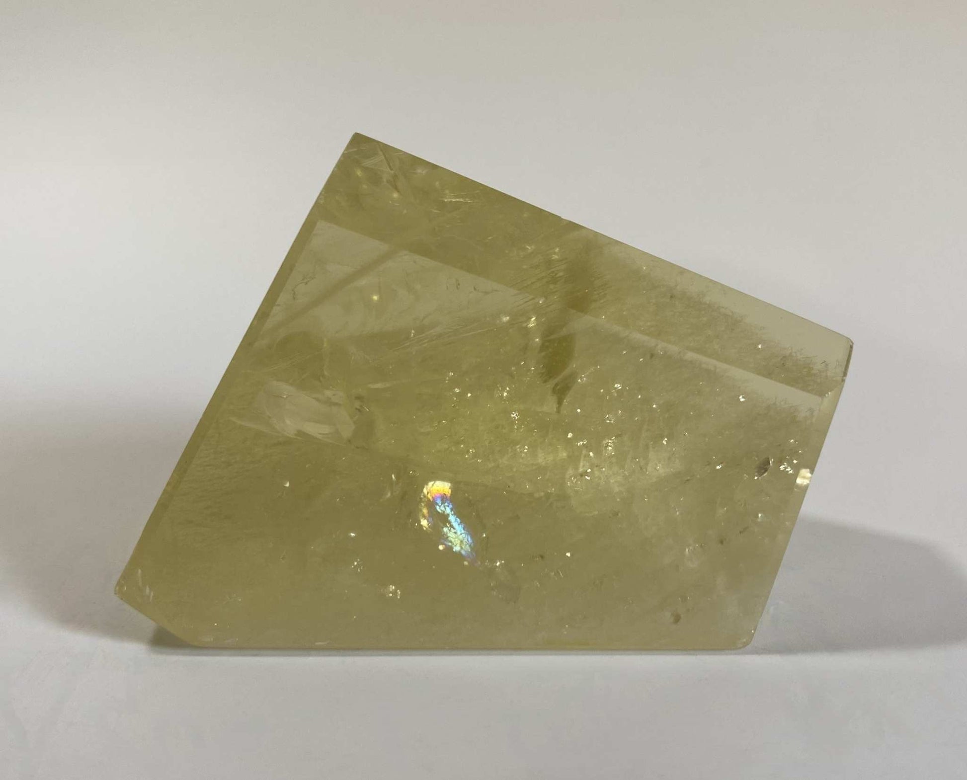 Forma Poligonala citrin semi-precious stone with polygonal shape on white background