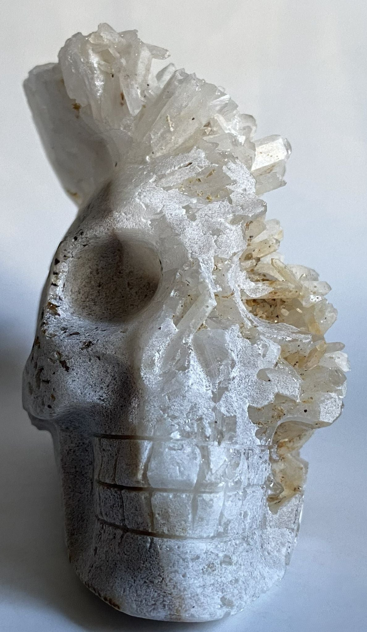 Cluster craniu din cristal de cuart transparent pe fundal alb