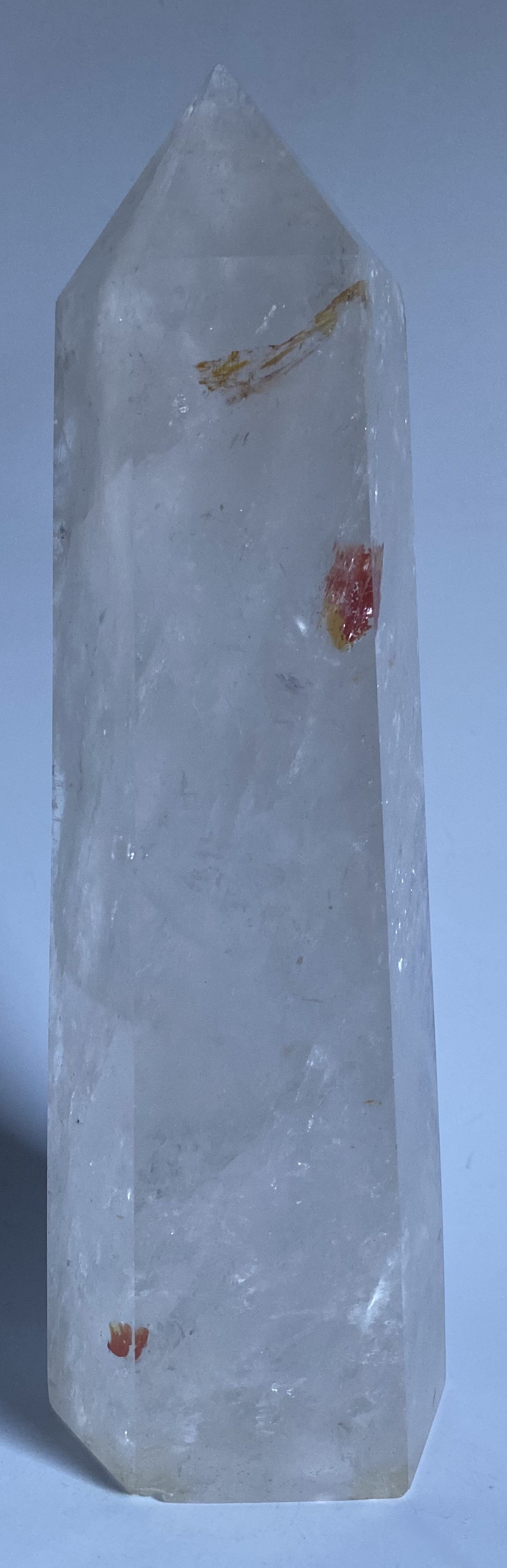 Obelisc de 22 cm din cristal de stanca pe fundal alb sub lumina naturala