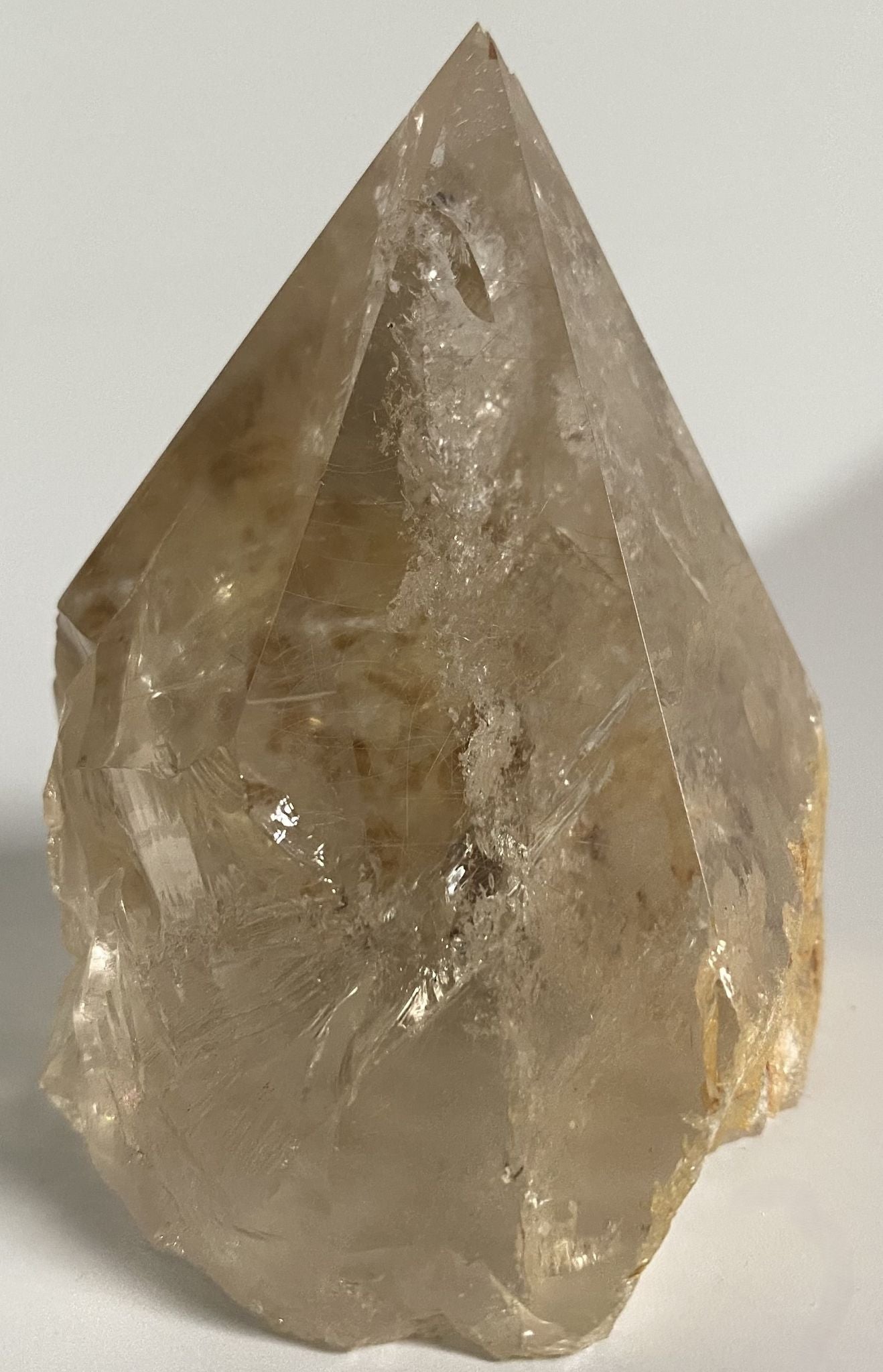 Varf polisat din cristal de cuart transparent pe fundal alb