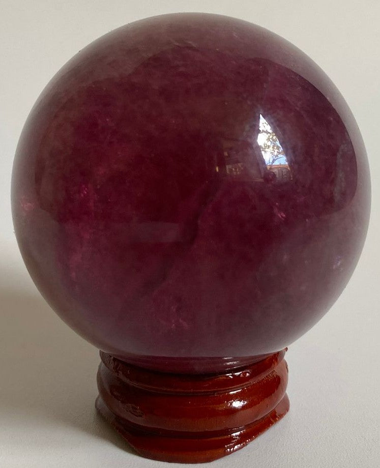 Sfera decorativa de 5.2cm din piatra semipretioasa de fluorit candy pe suport din lemn cu fundal alb