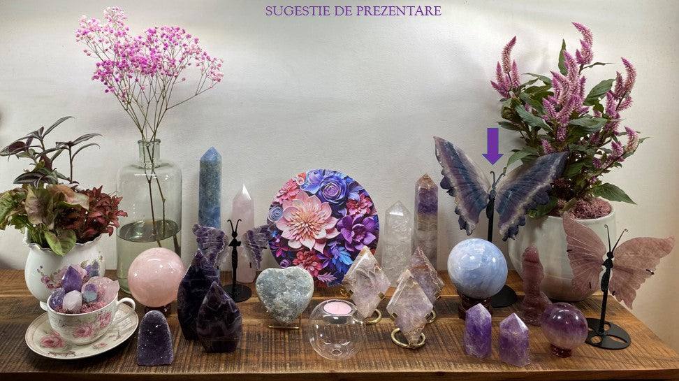 Fluorit semiprecious stone butterfly with metal stand displayed among crystals and flowers