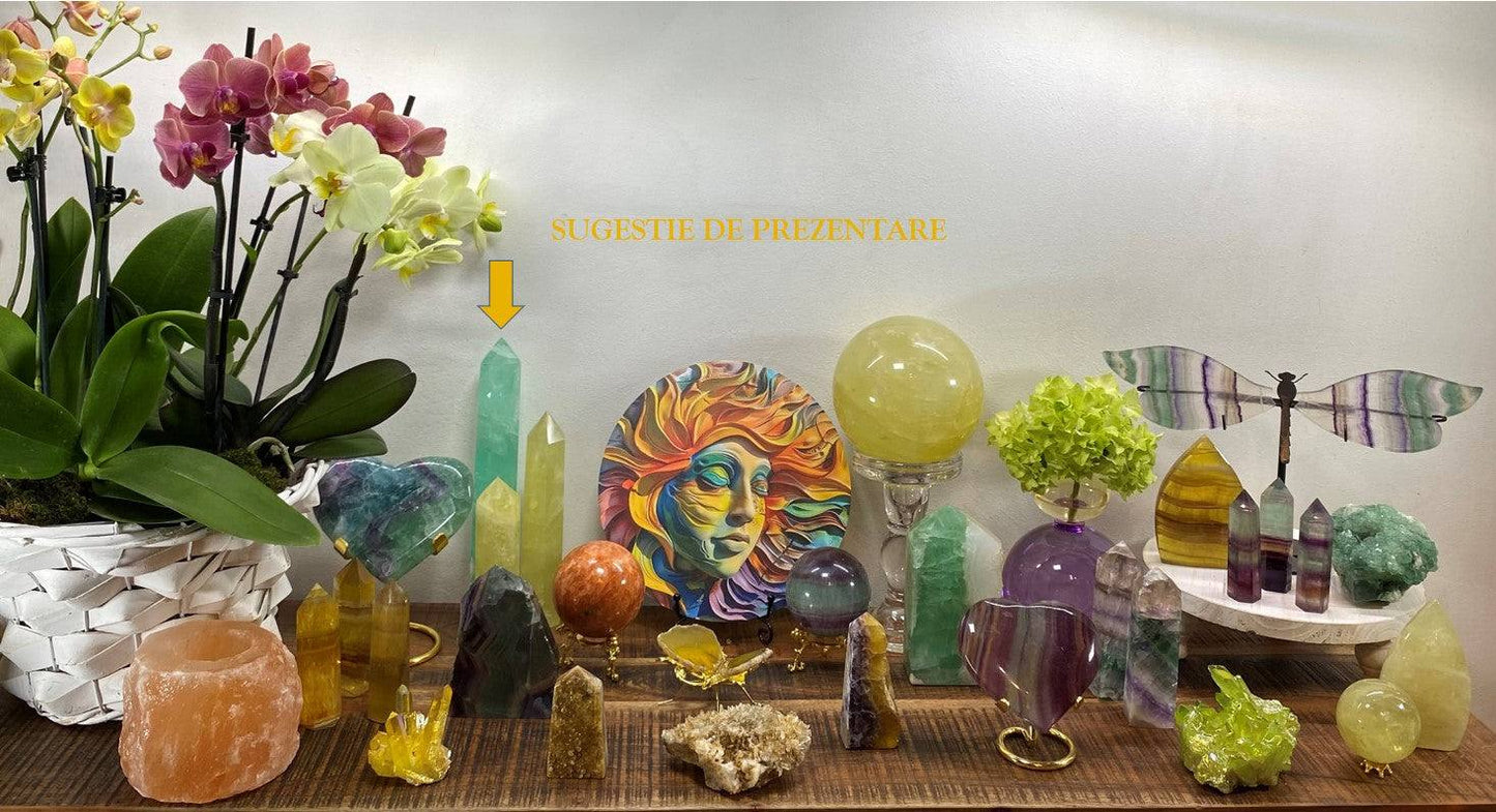 Green Fluorit obelisk semi-precious stone on display with crystals and decorative items