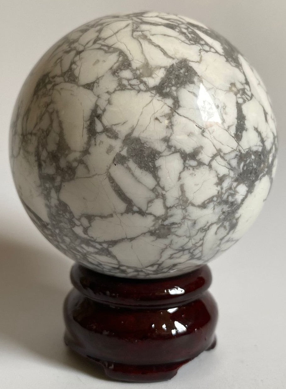 Sfera decorativa de 6.5cm din cristal de howlit pe suport din lemn cu fundal alb
