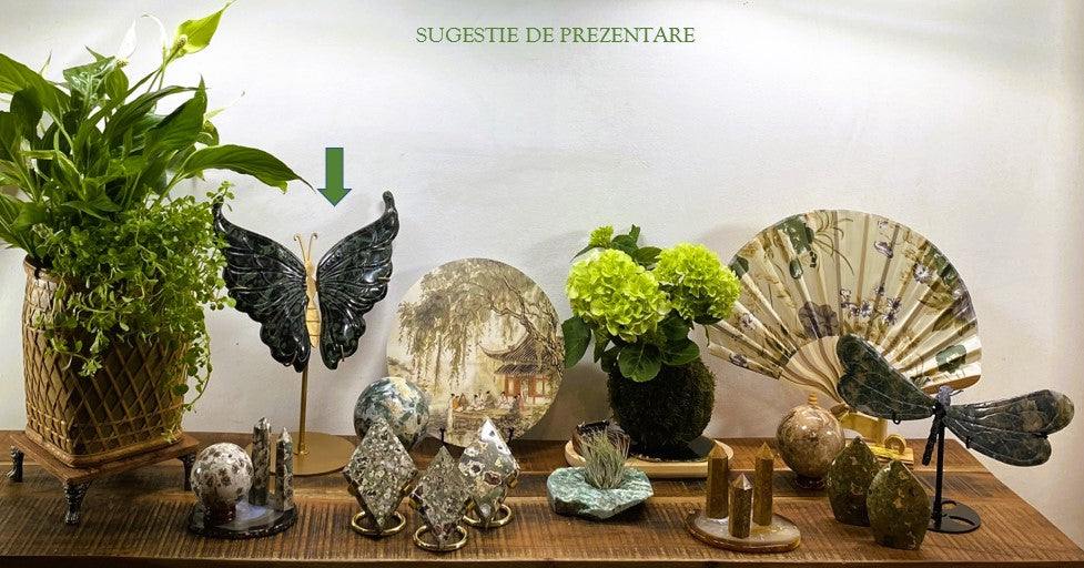 Jasp Kambaba butterfly stone sculpture with metal stand on wooden display table with plants and decorative items