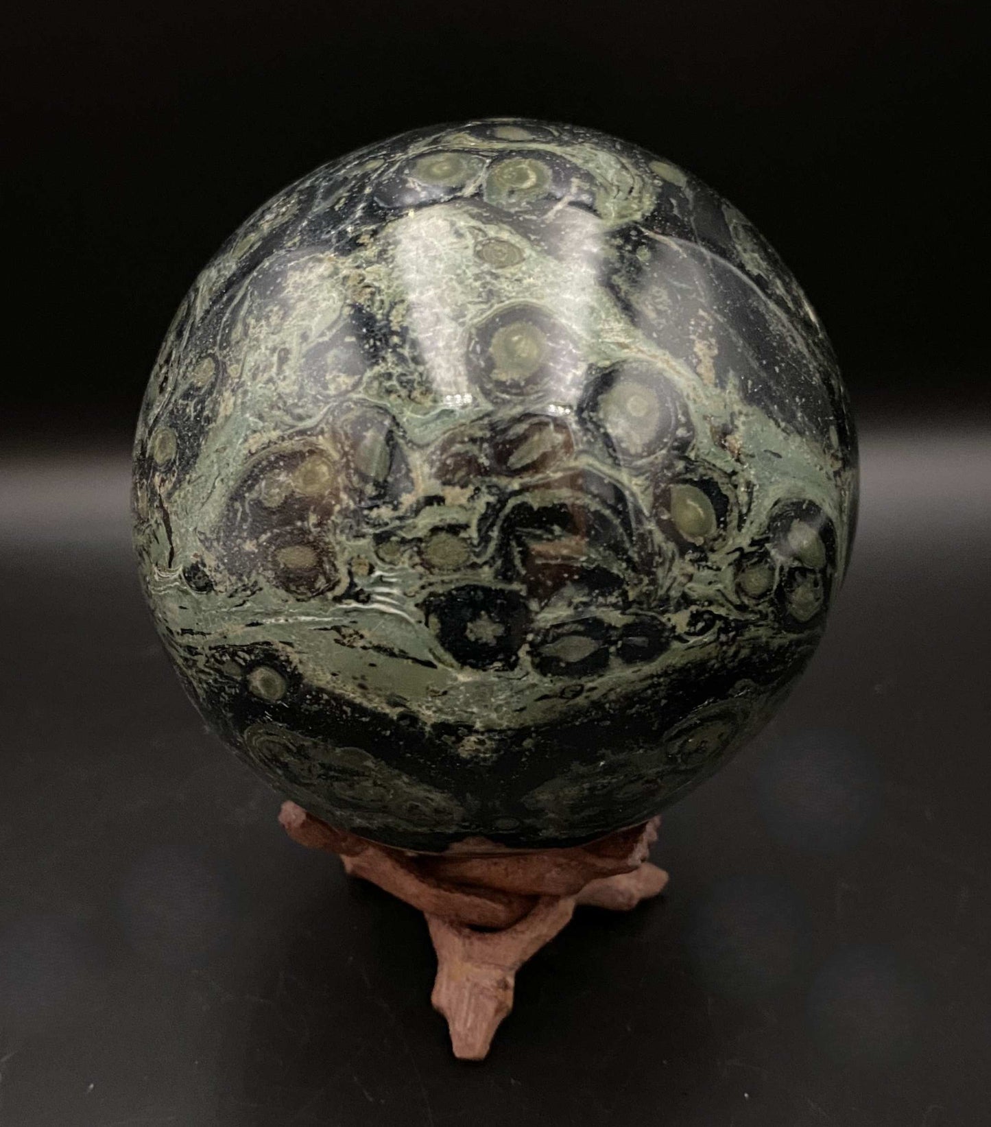 Jasp Kambaba polished sphere on wooden stand semiprecious stone decorative orb