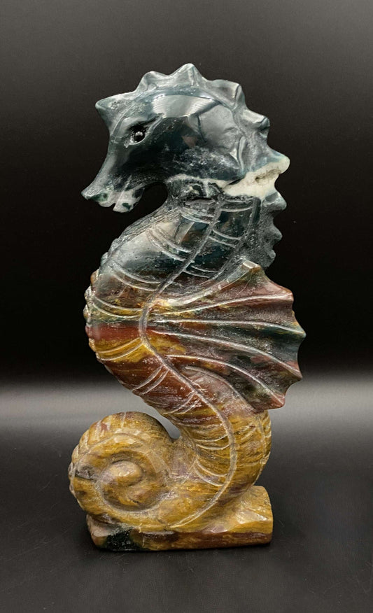 Jasp Oceanic carved seahorse gemstone figurine on black background