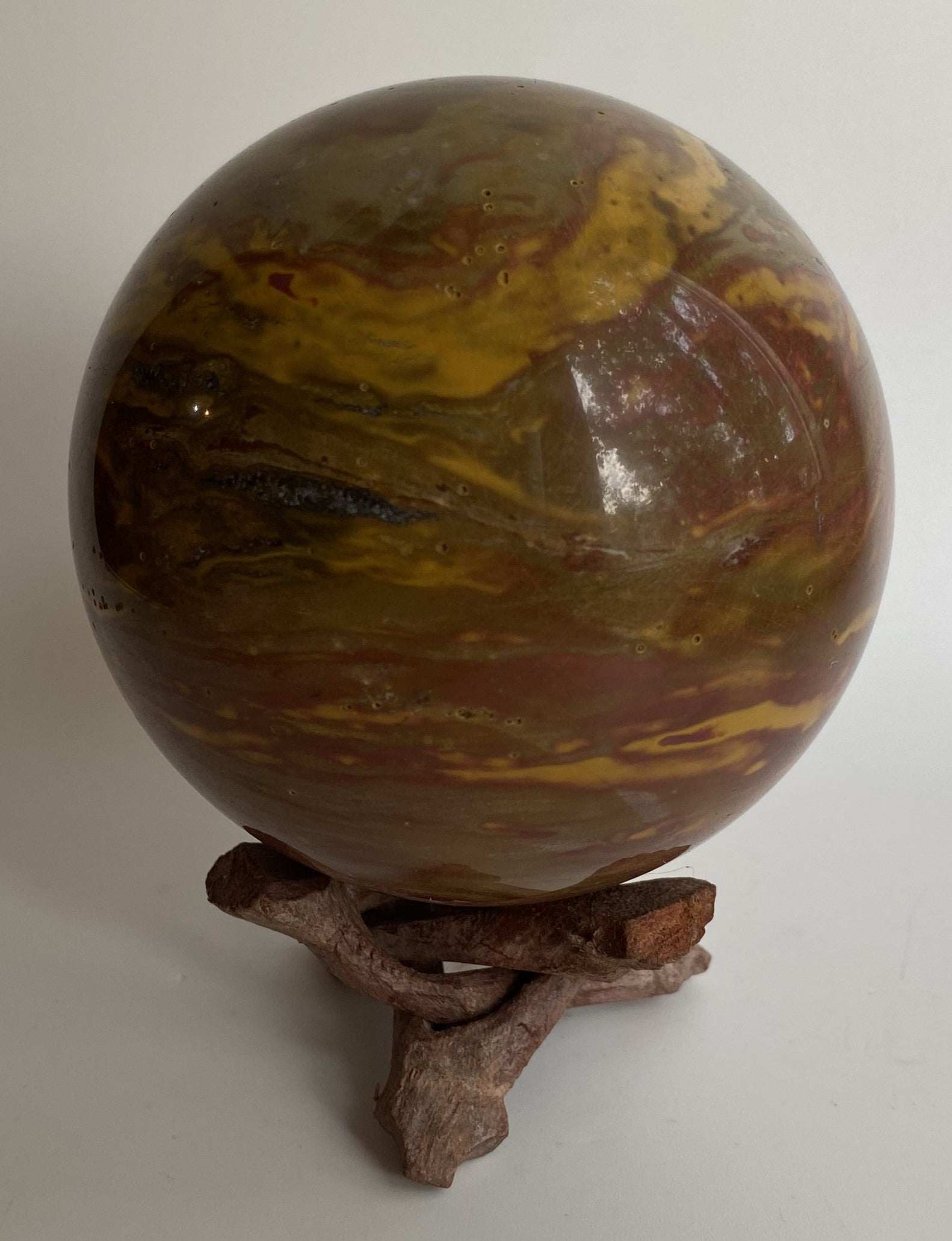 Jasp Oceanic polished sphere on wooden stand semi-precious stone decorative object