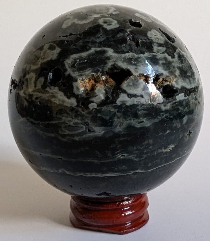 Sfera de 6.5cm din piatra semipretioasa de jasp oceanic verde pe suport din lemn cu fundal alb