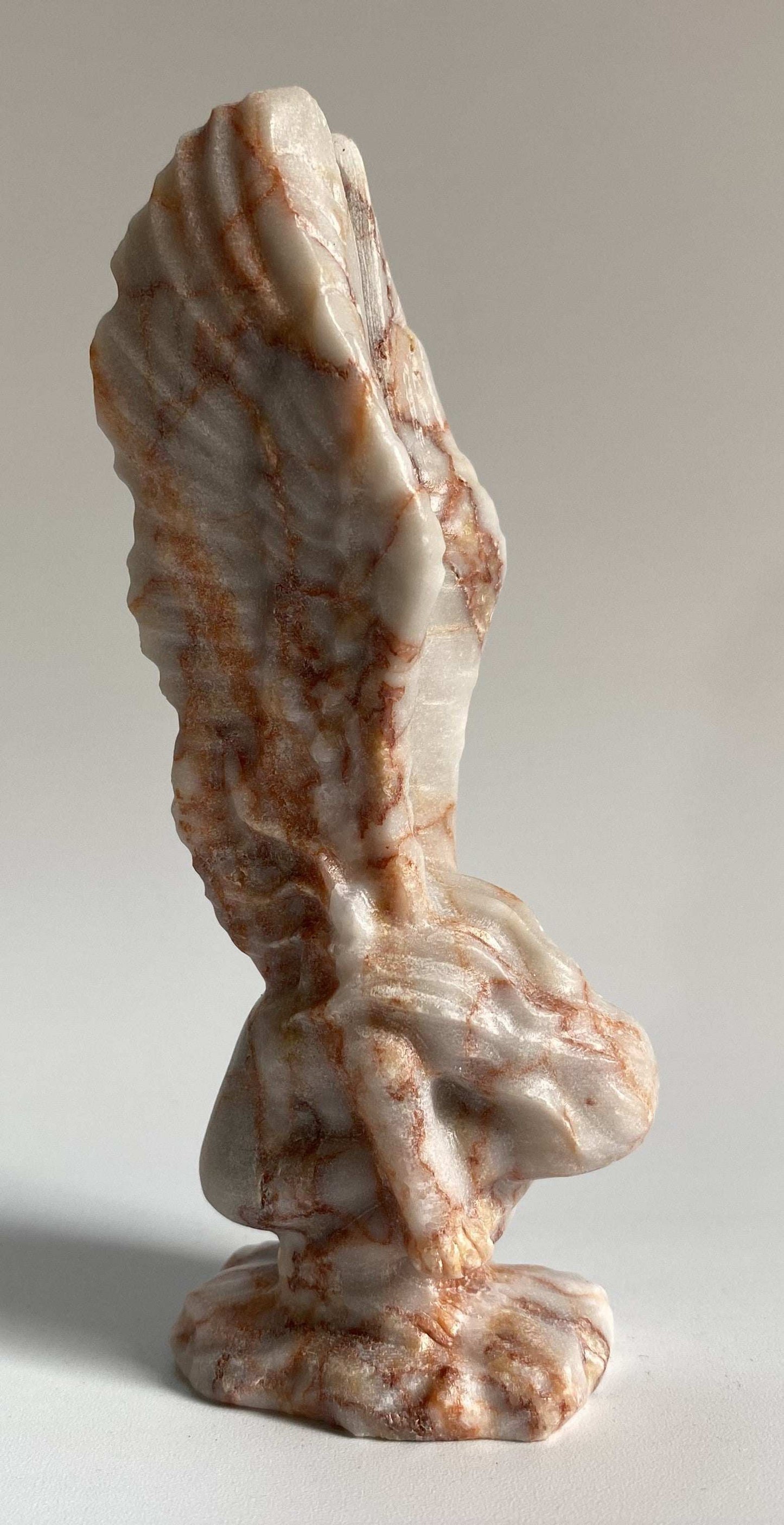 Carved angel figurine from Jasp Red Vein semi-precious stone with red and white streaks