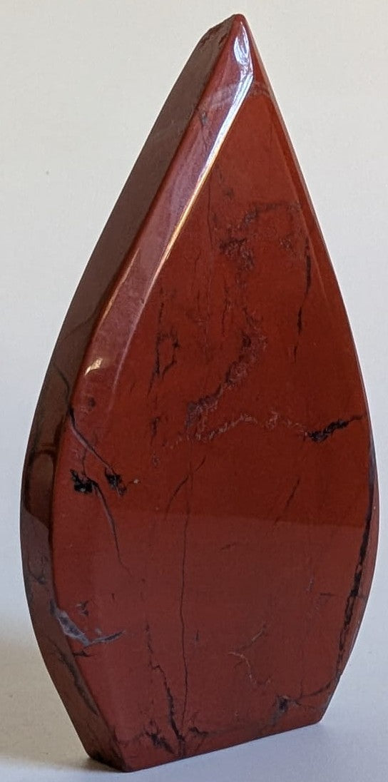 Sculptura din cristal de jasp rosu pe fundal alb