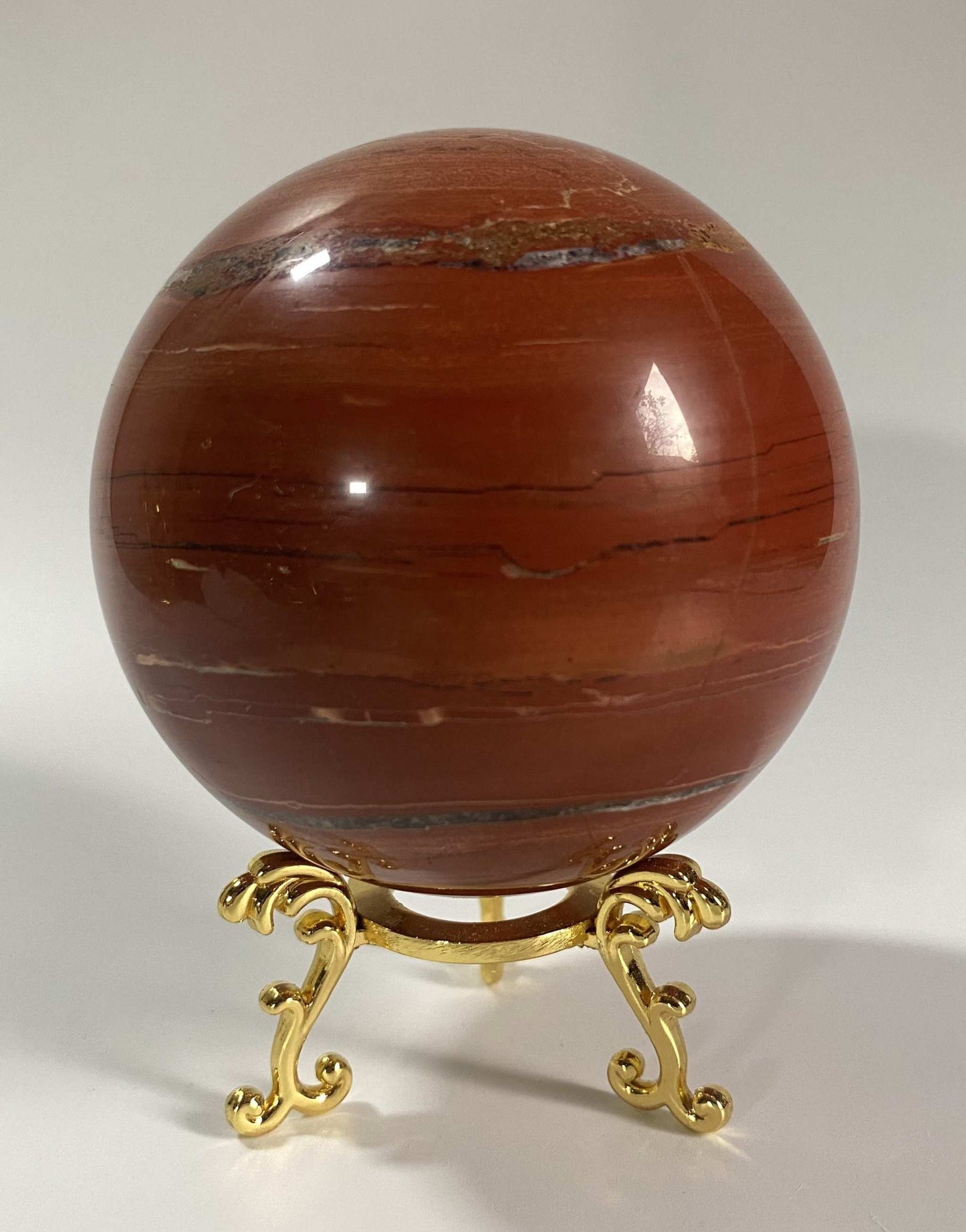 Jasp Rosu stone sphere on decorative metal stand