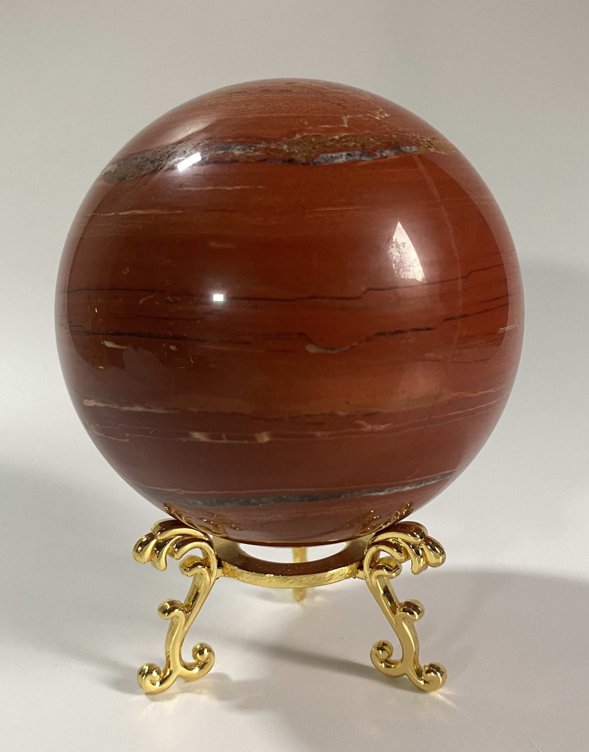 Jasp Rosu stone sphere on decorative metal stand