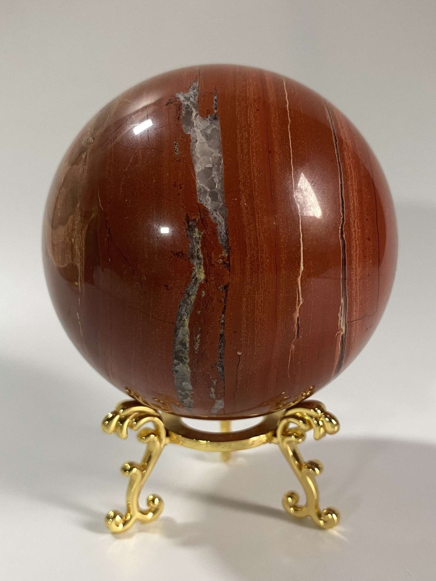 Red Jasper sphere gemstone on decorative metal stand Jasp Rosu semiprecious stone orb
