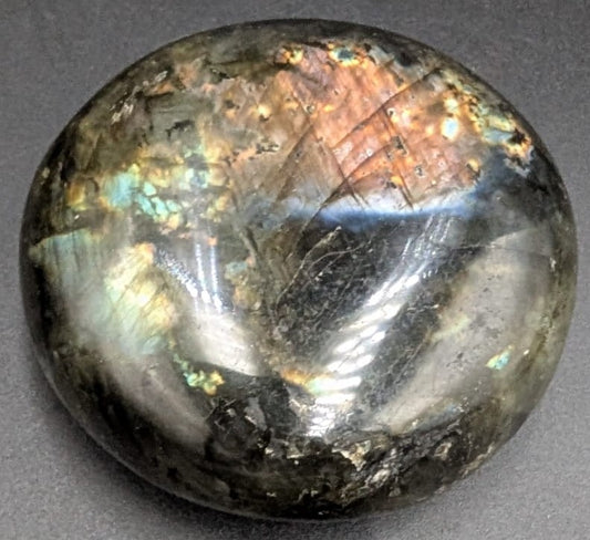 Palm Stone din piatra semipretioasa de labradorit pe fundal negru