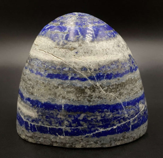 Polished Lapis Lazuli semi-precious stone sculpture with blue and gray stripes