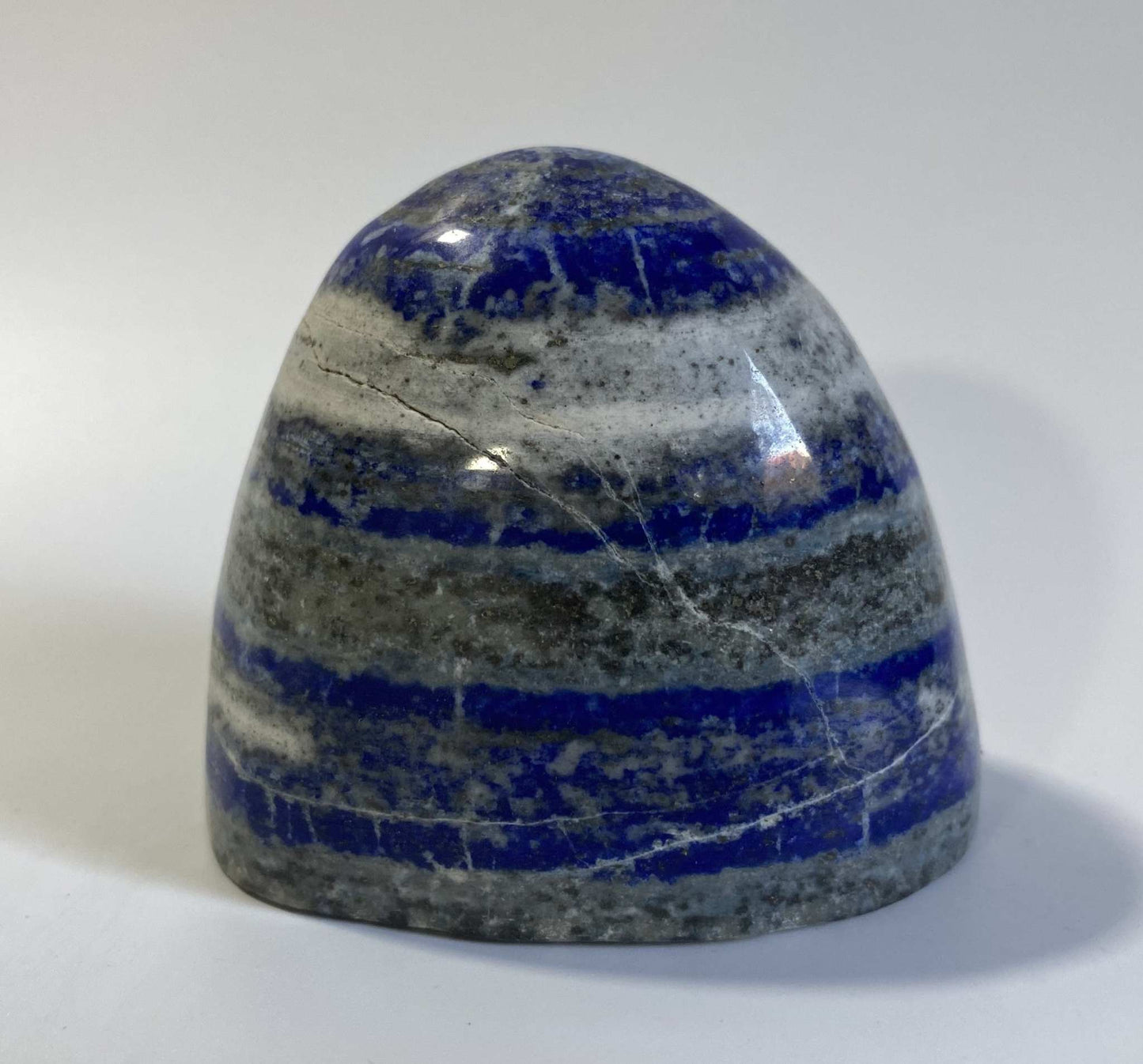 Polished Lapis Lazuli semi-precious stone sculpture with blue and gray layers