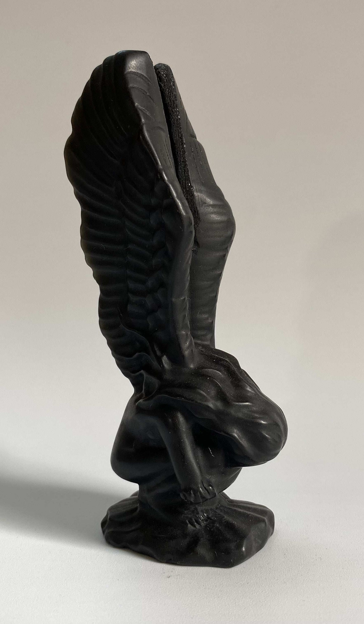 Obsidian angel figurine carved from black semiprecious stone with detailed wings