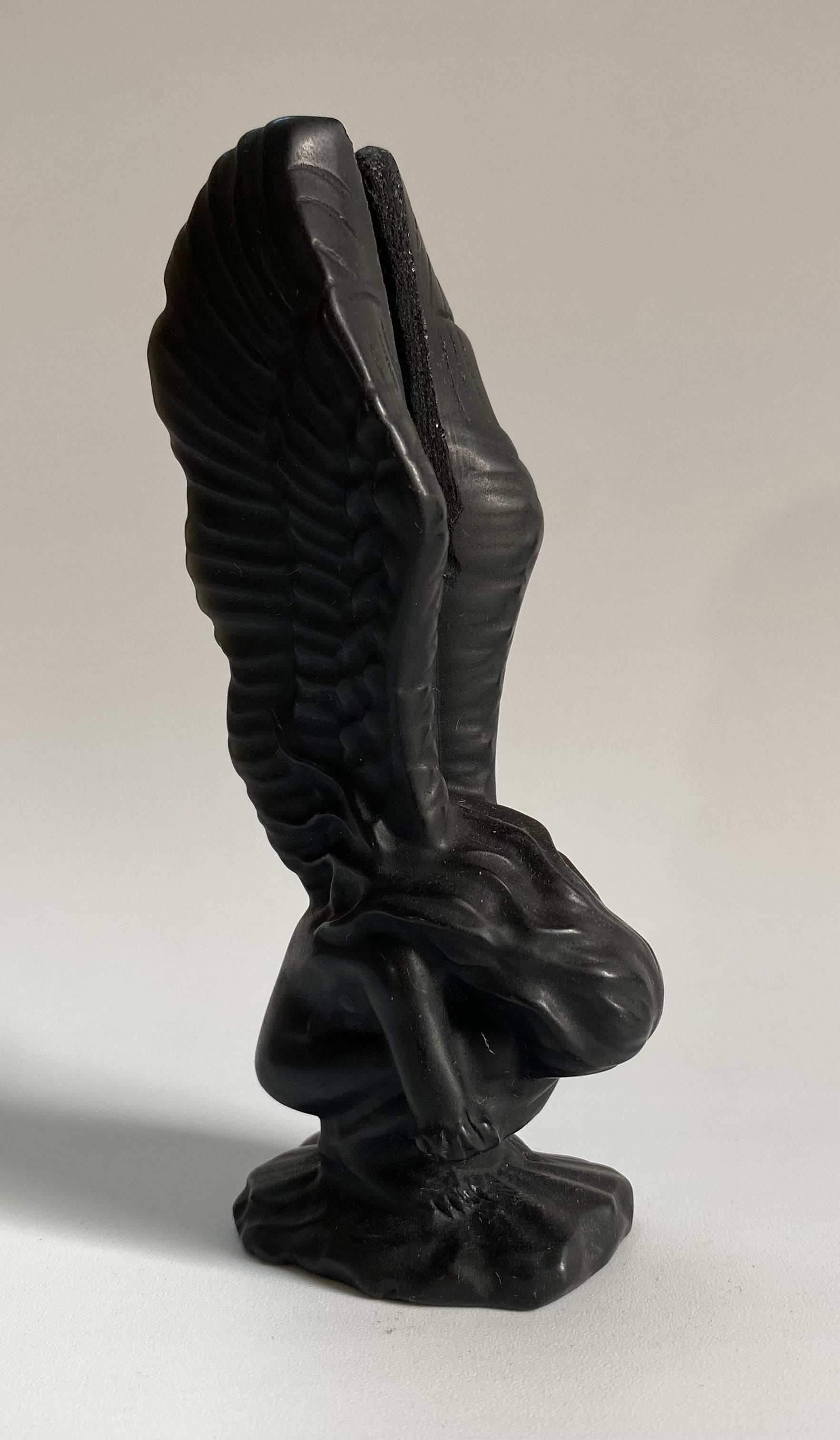 Obsidian angel figurine carved from black semiprecious stone with detailed wings