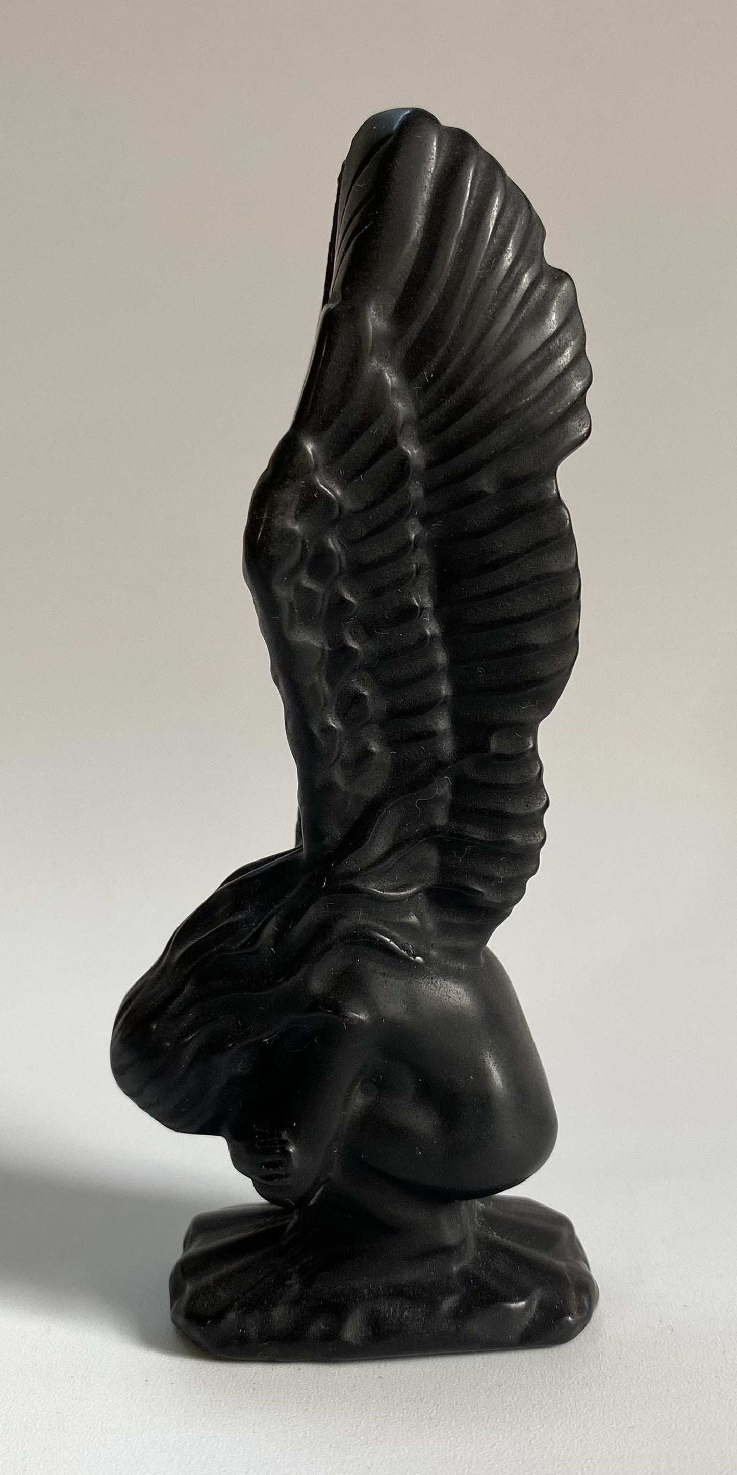Obsidian angel figurine carved from semi-precious stone with detailed wings and kneeling position