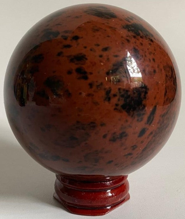 Sfera decorativa de 6.5cm din piatra semipretioasa de obsidian mahon pe suport din lemn cu fundal alb