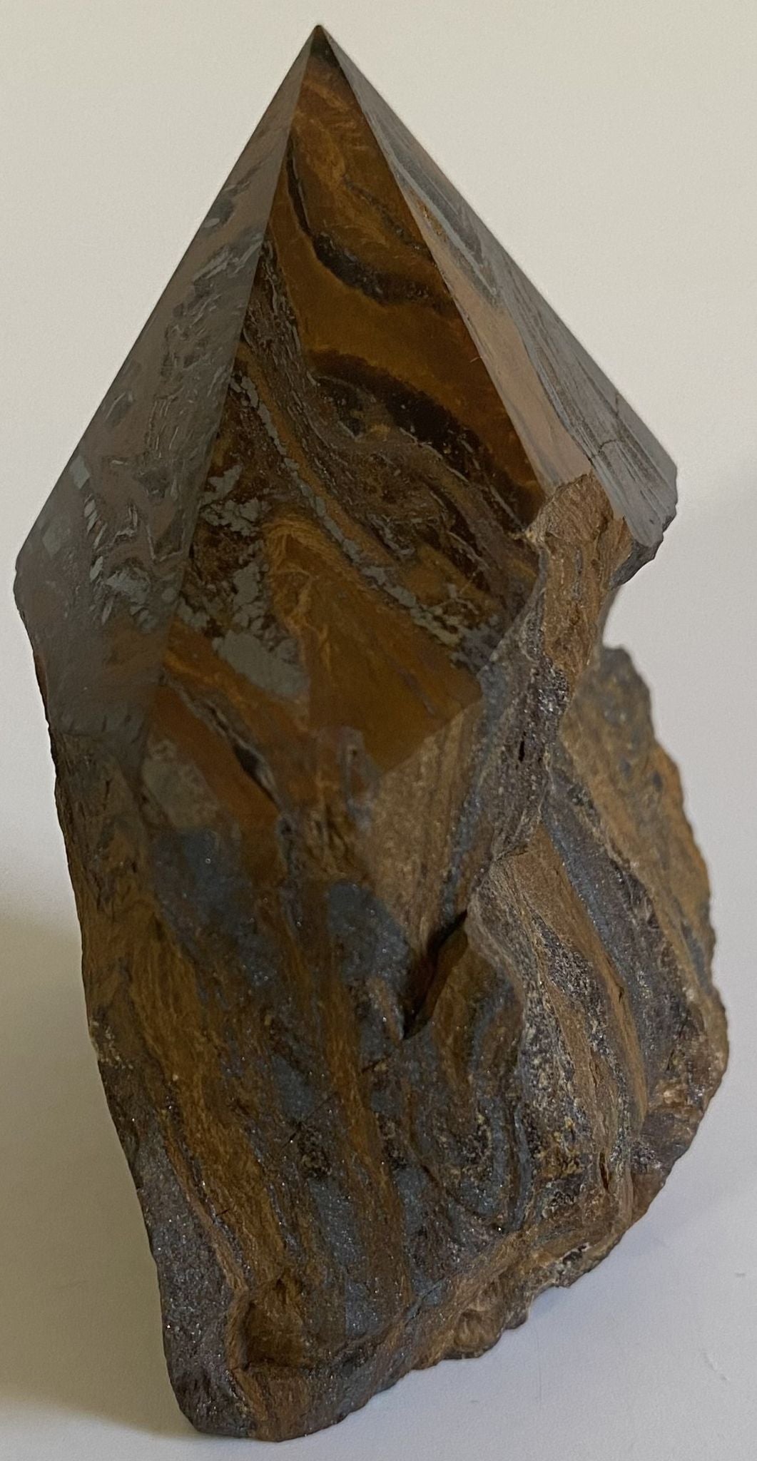 Varf polisat de 8.2cm din cristal de ochi de tigru cu fier pe fundal alb