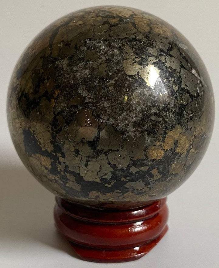 Sfera de 5cm din cristal de pirita pe suport din lemn cu fundal alb