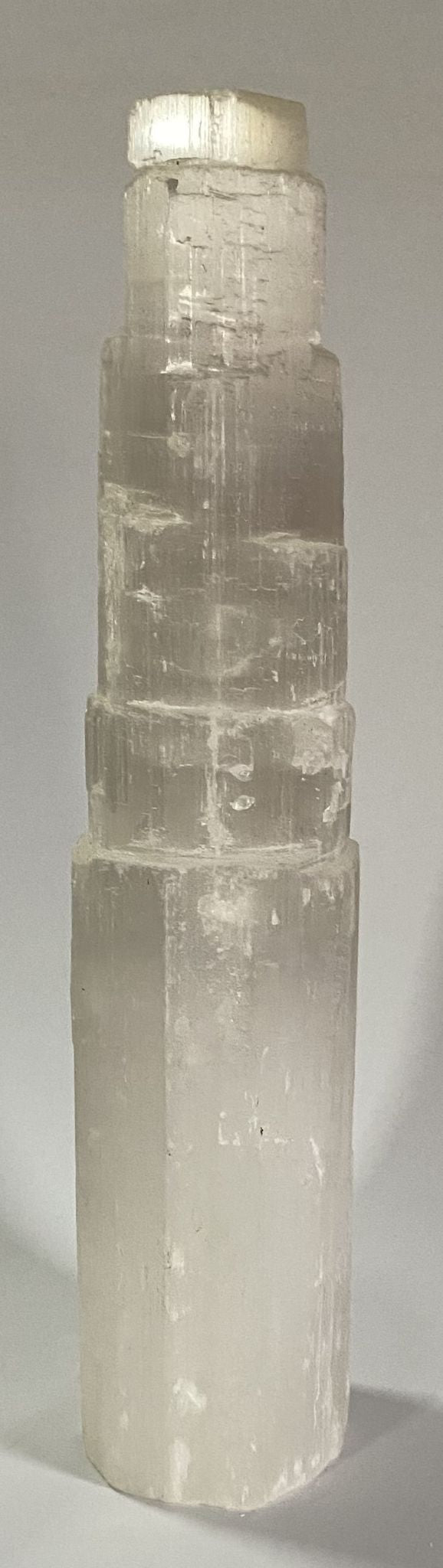 Turn alb translucid din piatra semipretioasa de selenit pe fundal alb